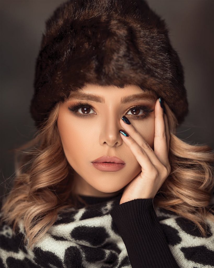 Woman In Winter Clothes Holding Her Face